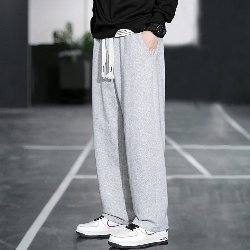 Men's grey casual trousers with multiple pockets showing high waist design and full length