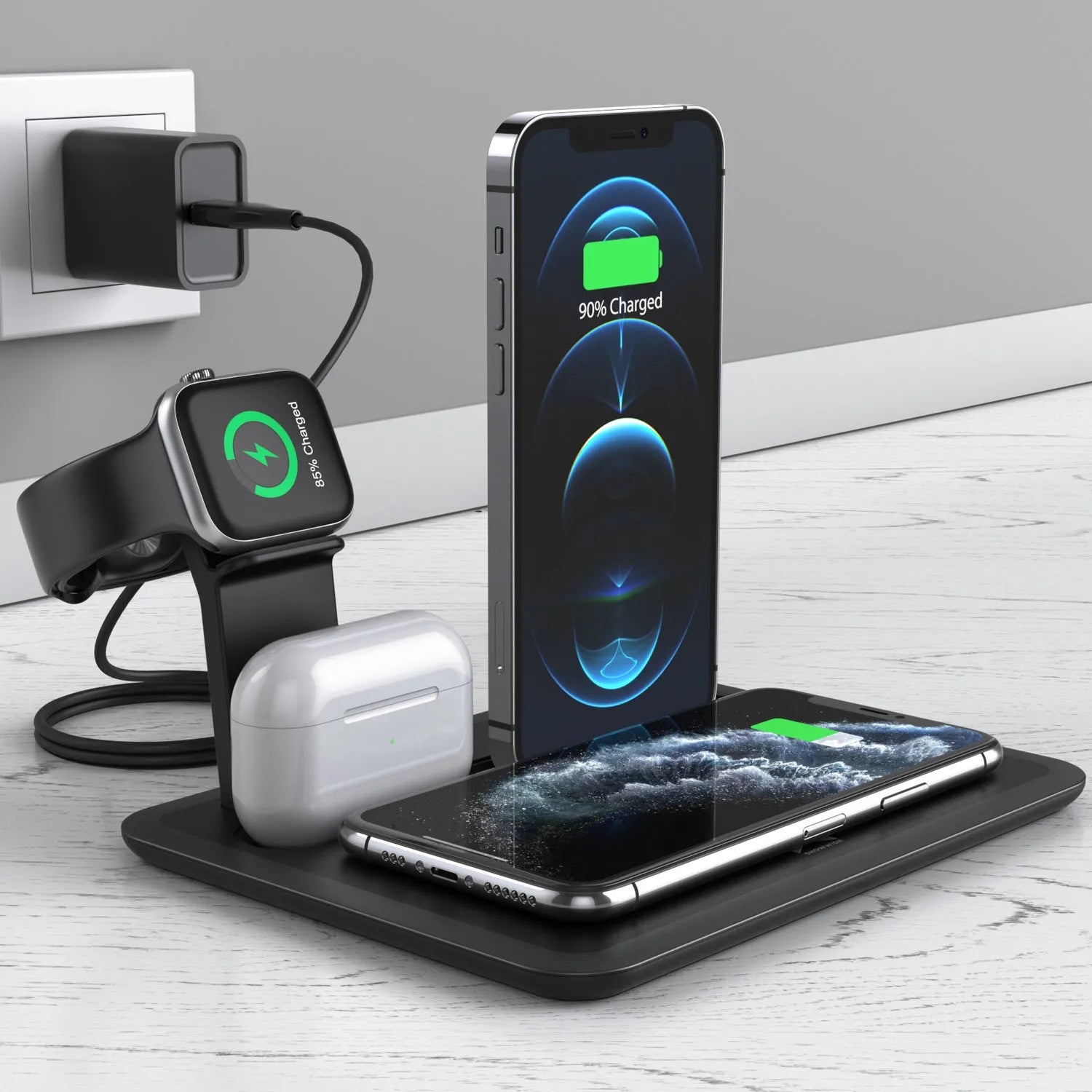 Black desktop wireless charger with phone on pad, watch and headphone cables connected.