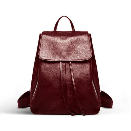 Black genuine leather women's backpack with street trend style and multiple internal pockets.