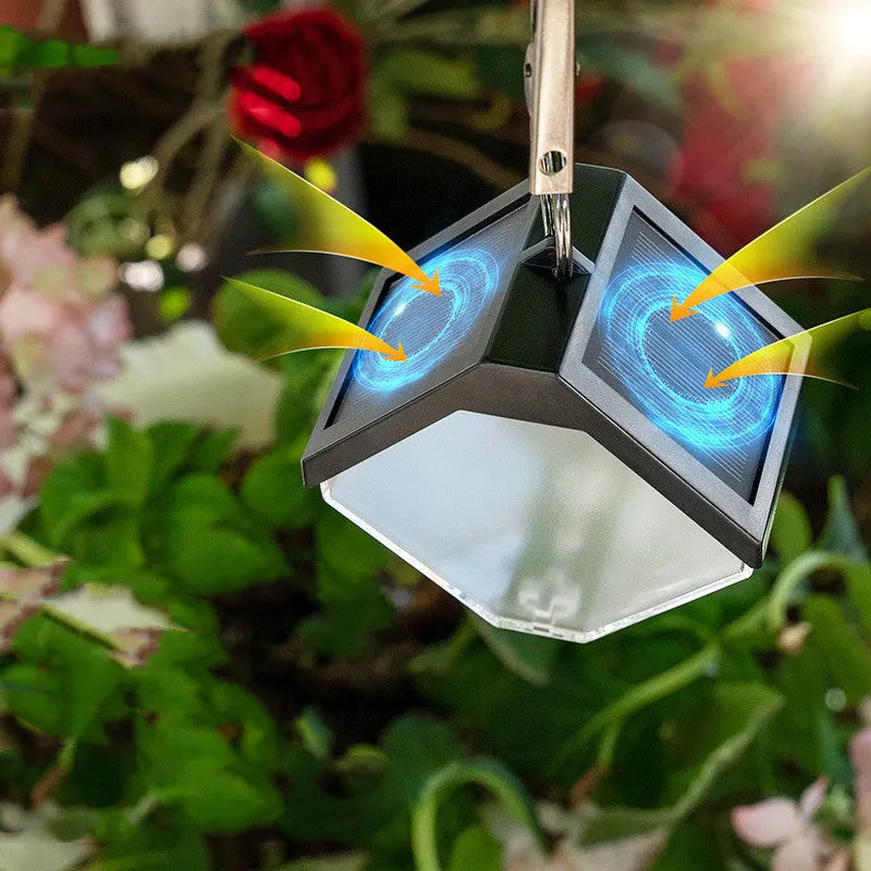 Outdoor solar ice brick chandelier with dual colour LED warm and colour light hanging in a garden