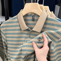 Man wearing a red and blue striped short sleeve casual shirt with a mosaic pattern.
