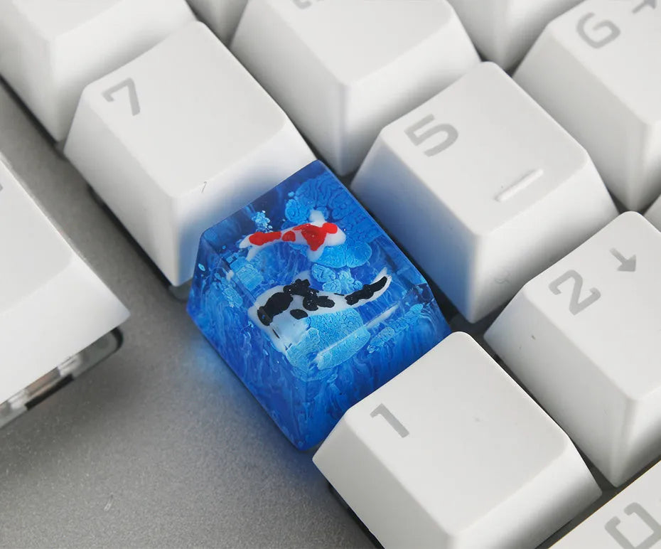 Resin keycap with koi fish swimming through scenery design for Cherry MX mechanical keyboards