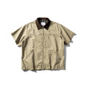 A khaki-coloured, loose-fitting, short-sleeved cotton shirt styled as washed overalls for teenagers