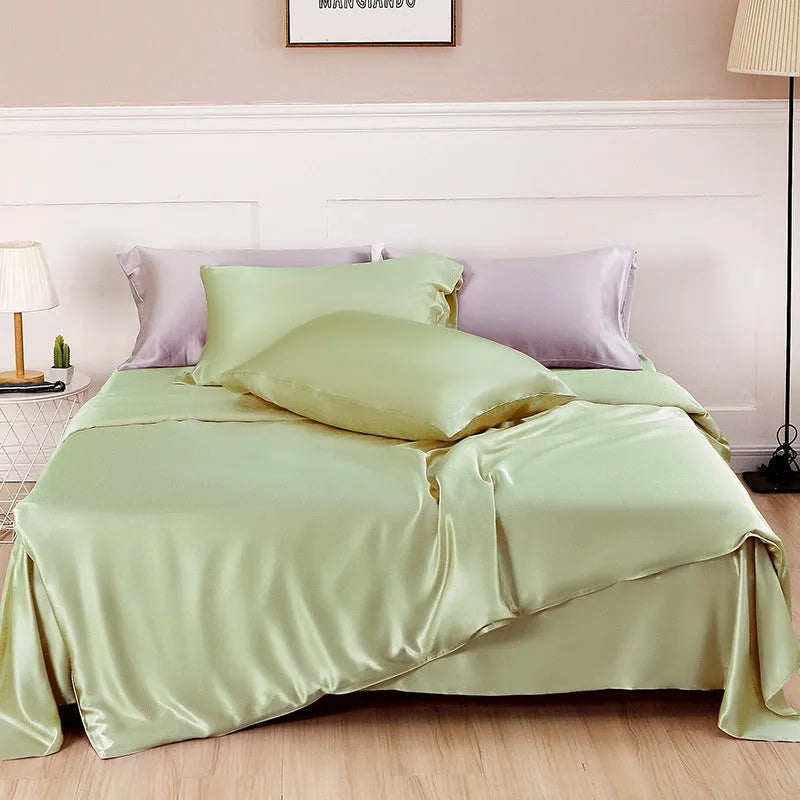 Double-sided silk duvet cover in plain weave, shown in one of six solid colours, laid flat on a bed.