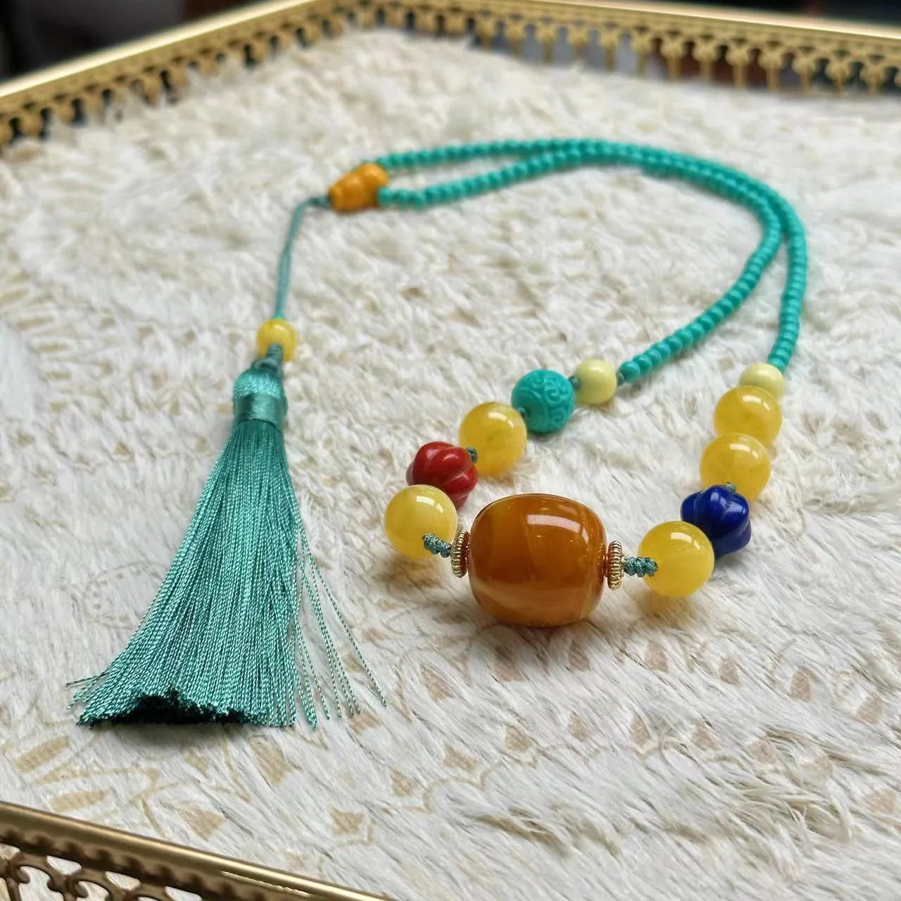 Turquoise mesh flower lucky pendant necklace on an adjustable ball bead chain.