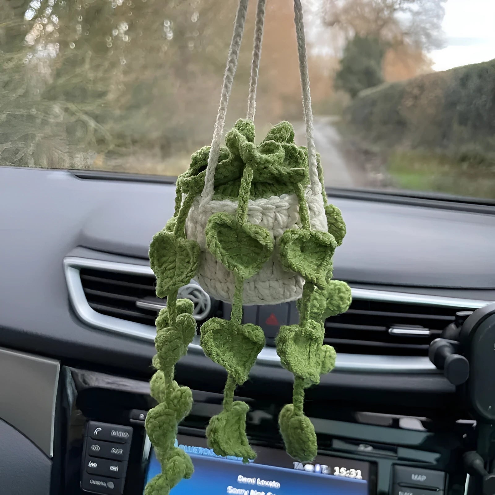 Green and white knitted wool plant ornament for car dashboard with hanging cord