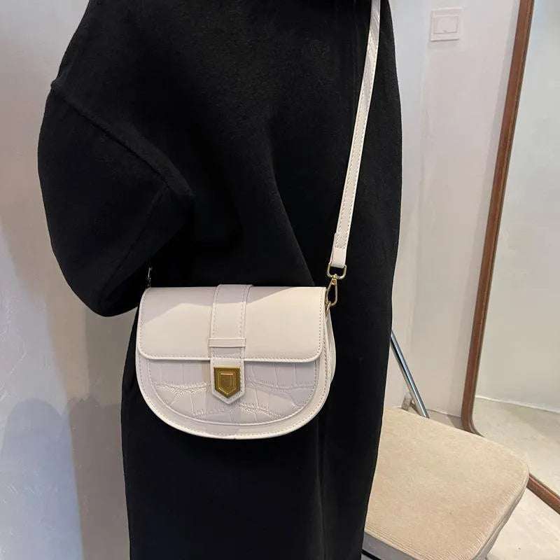 French one shoulder saddle bag for women with lock and stone pattern, available in beige