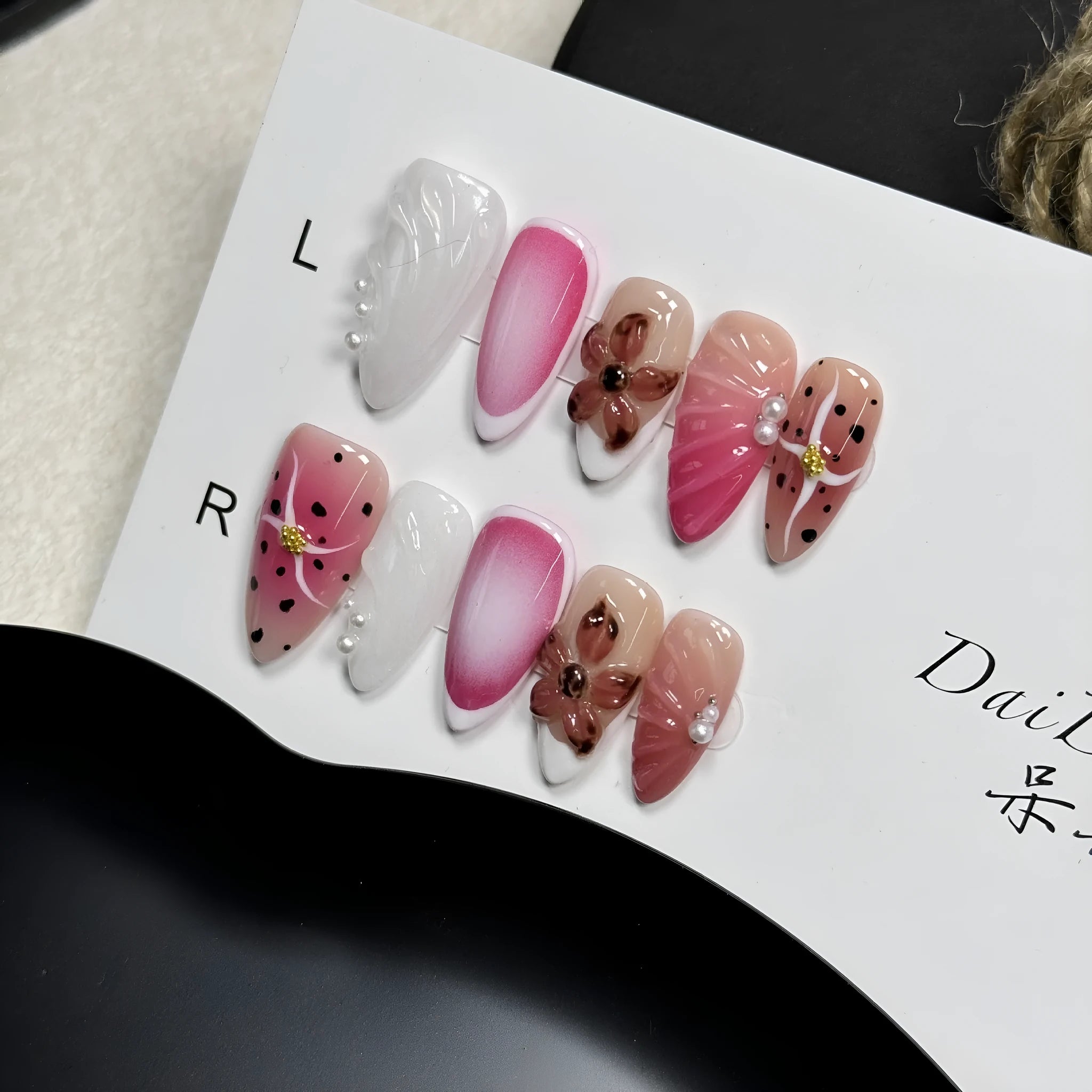 Close-up of hand-painted 3D carved nail art patches with colourful embossed candy patterns.