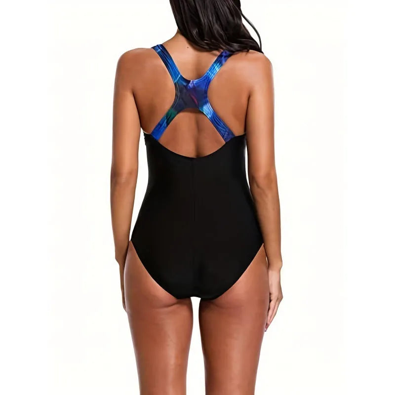 Woman wearing an oversized floral print one-piece swimsuit with a backless design.