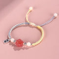 Handmade red cat's paw charm bracelet with pink woven band for couples.