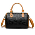 Brown cylindrical PU crossbody bag with three adjustable shoulder straps on a plain background.