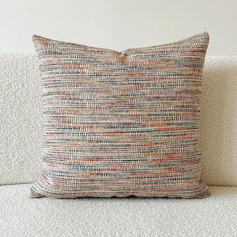 American-style jacquard woven throw pillow cover with a paisley pattern in amber colours on a sofa.