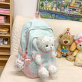 Nylon school backpack in a macaron colour with curved shoulder straps and sewing line detail.