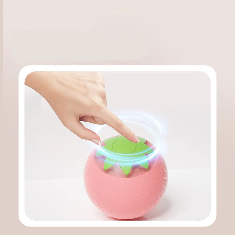 Green rolling ball electric pet toy for dogs and cats on indoor floor surface