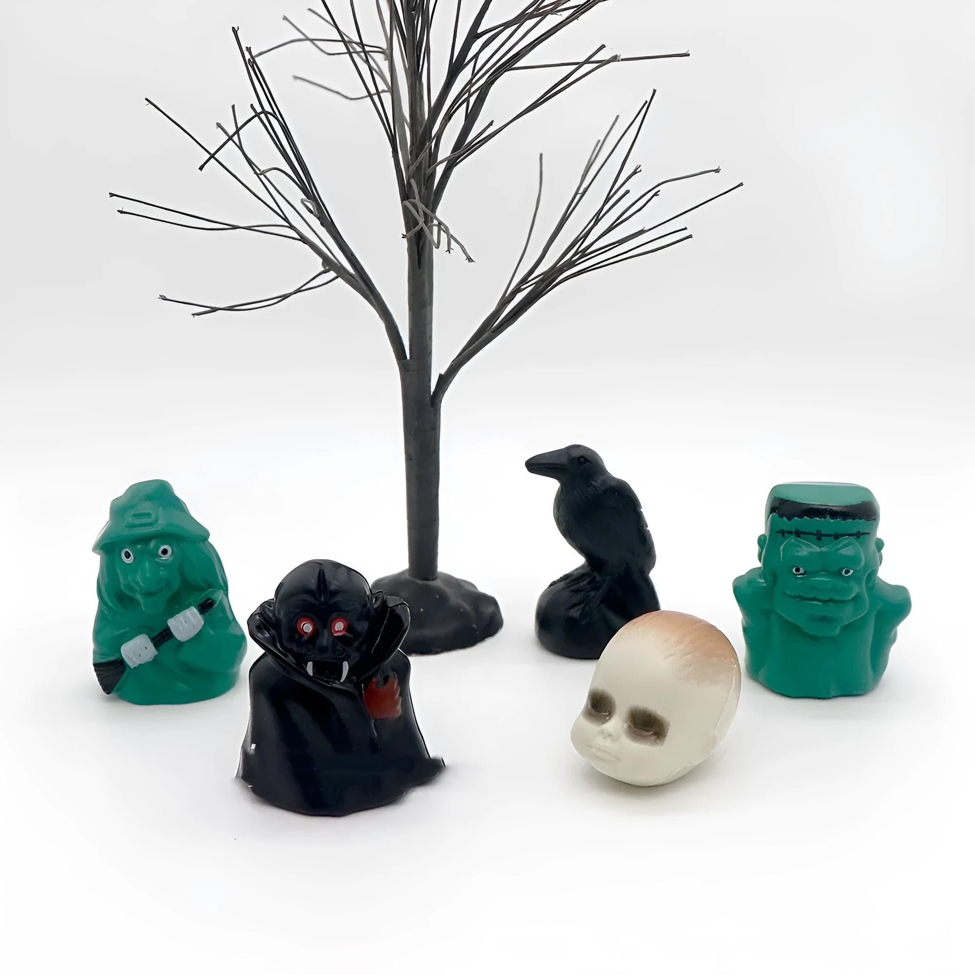 Plastic Halloween ornament of a witch green baby head for scene decoration