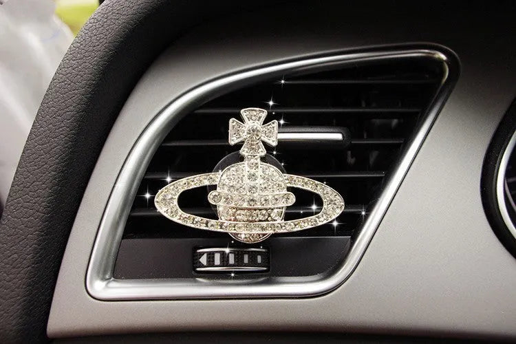 Alloy car fragrance clip with decorative charm attached to car air vent