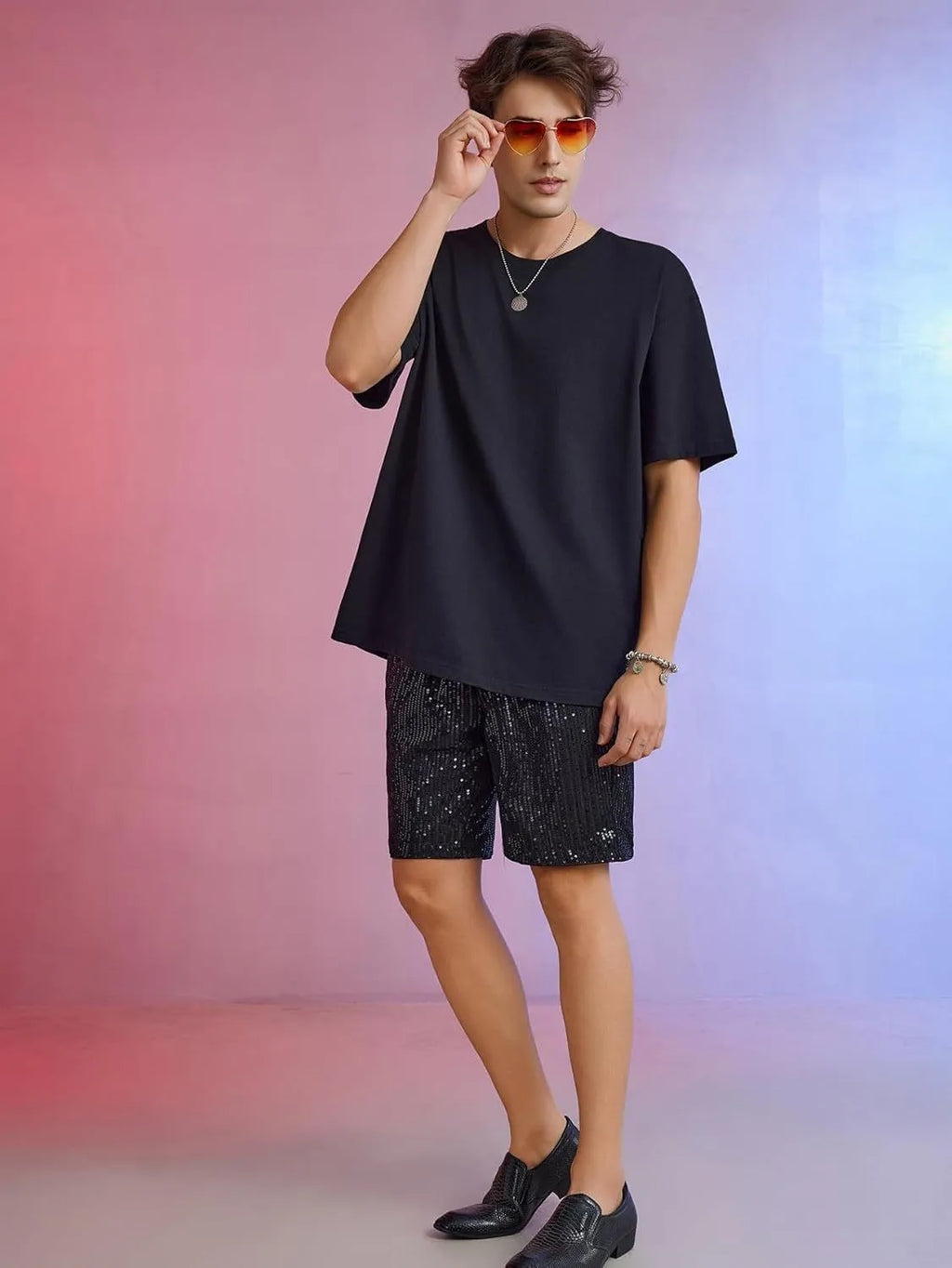 Men's silver sequin shorts with straight fit design and elastic waistband shown on hanger