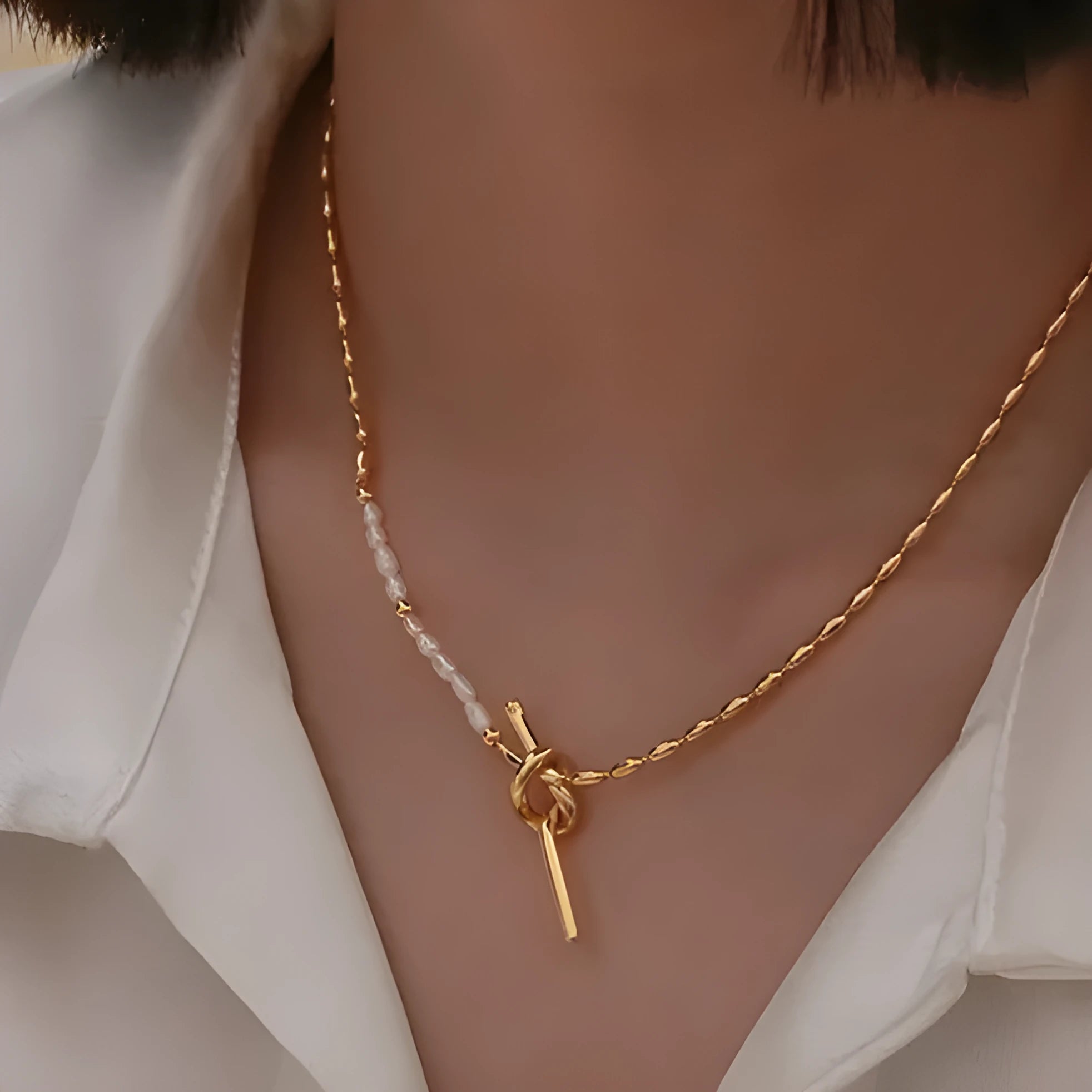 Gold electroplated natural real pearl necklace with copper geometric pendant and ring-line design on white background