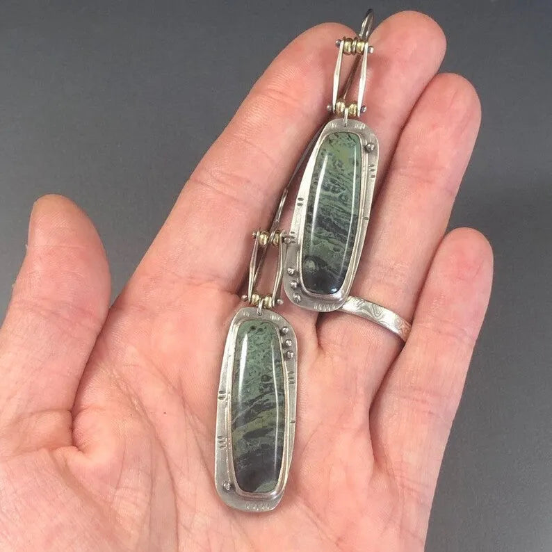 A pair of women's geometric-shaped alloy earrings with a two-tone marble pattern finish.