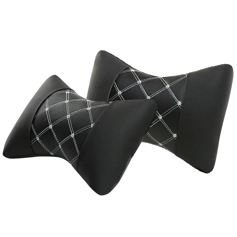 Black quilted leather car headrest pillow with diamond pattern and red stitching for neck support.