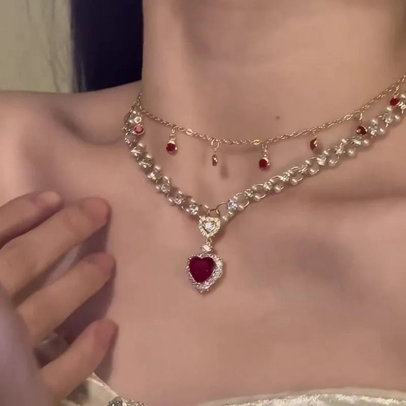 Red alloy double layer necklace with a love heart pendant on a regular chain.