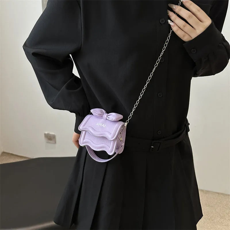 Mini crossbody bag in PU leather with adjustable strap, shown in multiple colour options