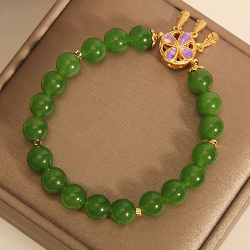 Green jasper crystal four-leaf clover dream catcher pendant bracelet on a natural cotton cord.