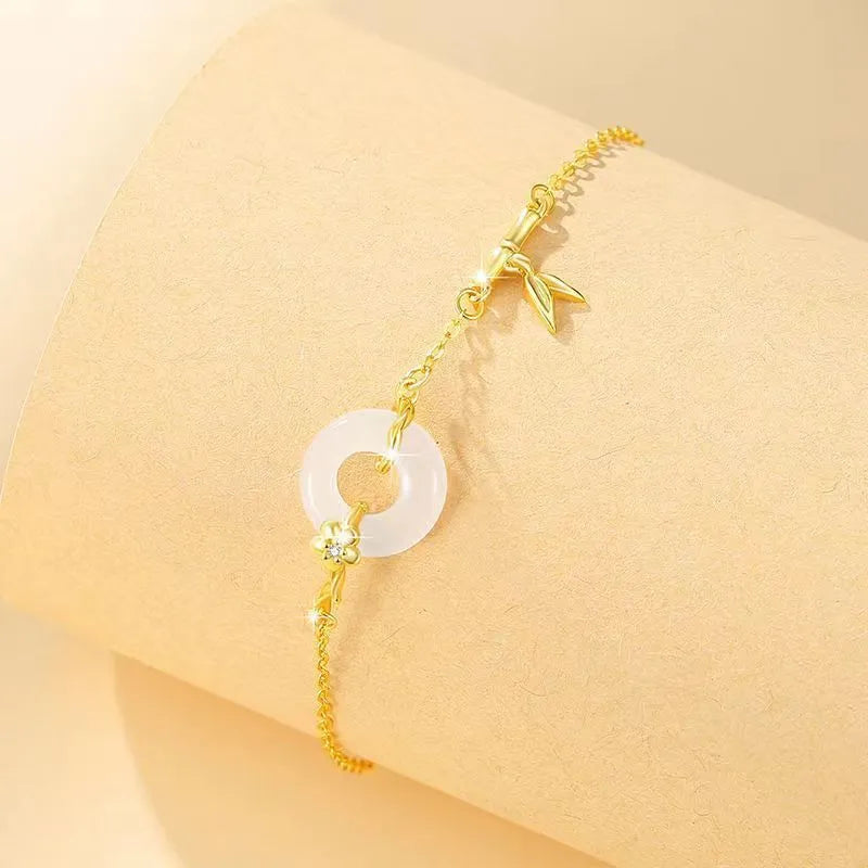 Women's silver bracelet with peace buckle clasp and white chalcedony gemstones in gold finish