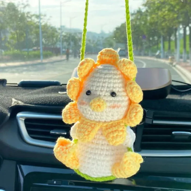 Green and white knitted wool plant ornament for car dashboard with hanging cord