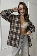 Dark brown striped women's long sleeve shirt in retro style on a hanger