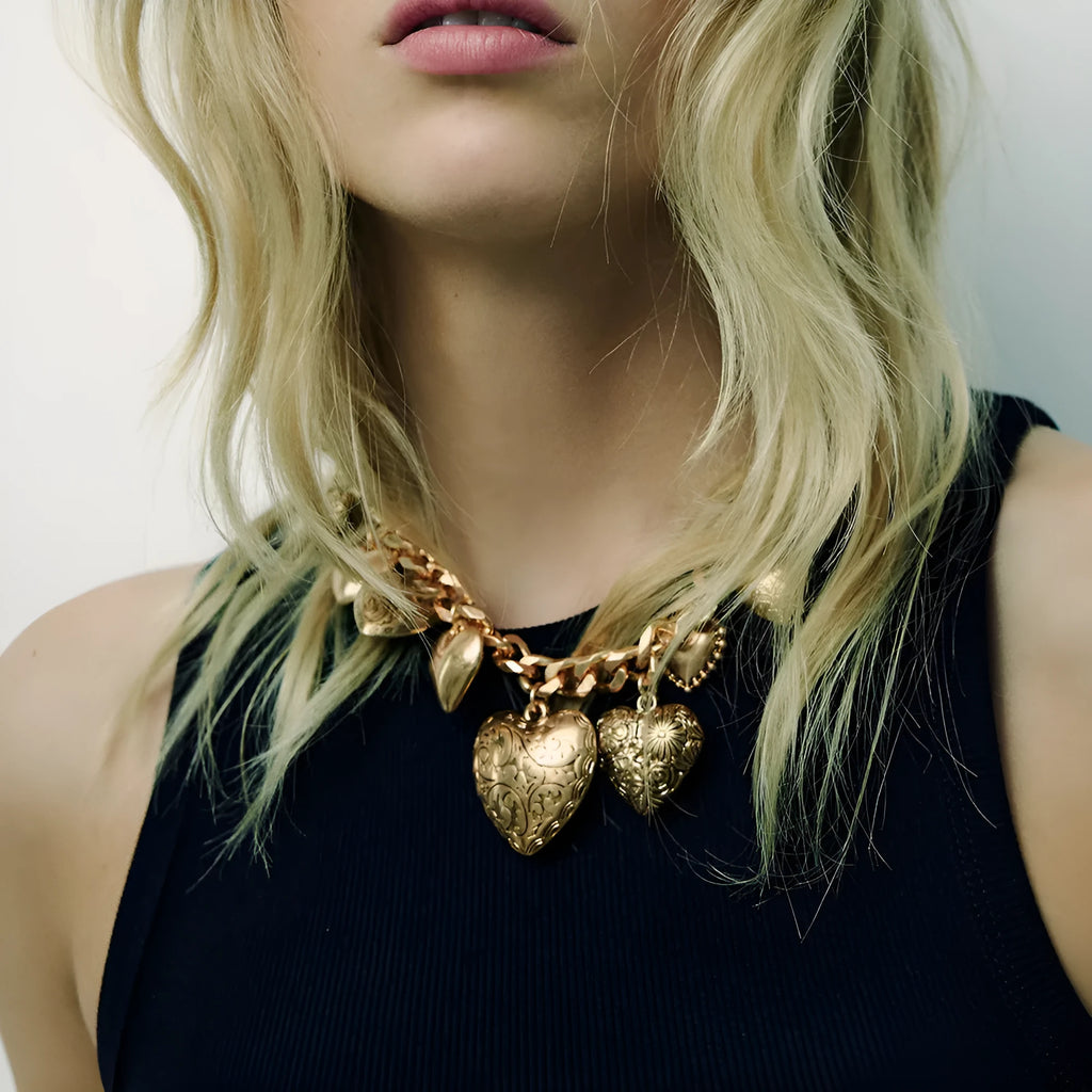 Gold carved heart pendant necklace on a metal chain, adjustable from 41cm to 50cm.