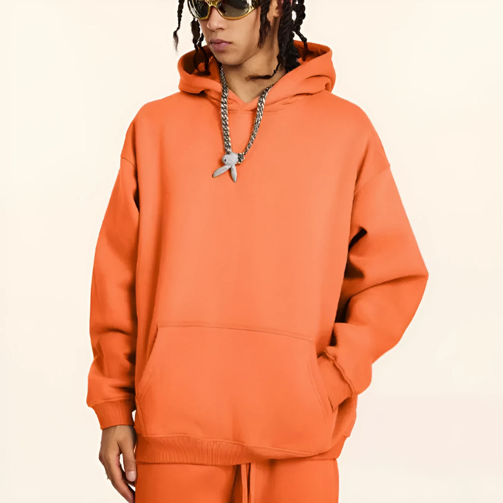 Men's grey terry cotton hooded sweater showing loose fit and drop-shoulder design