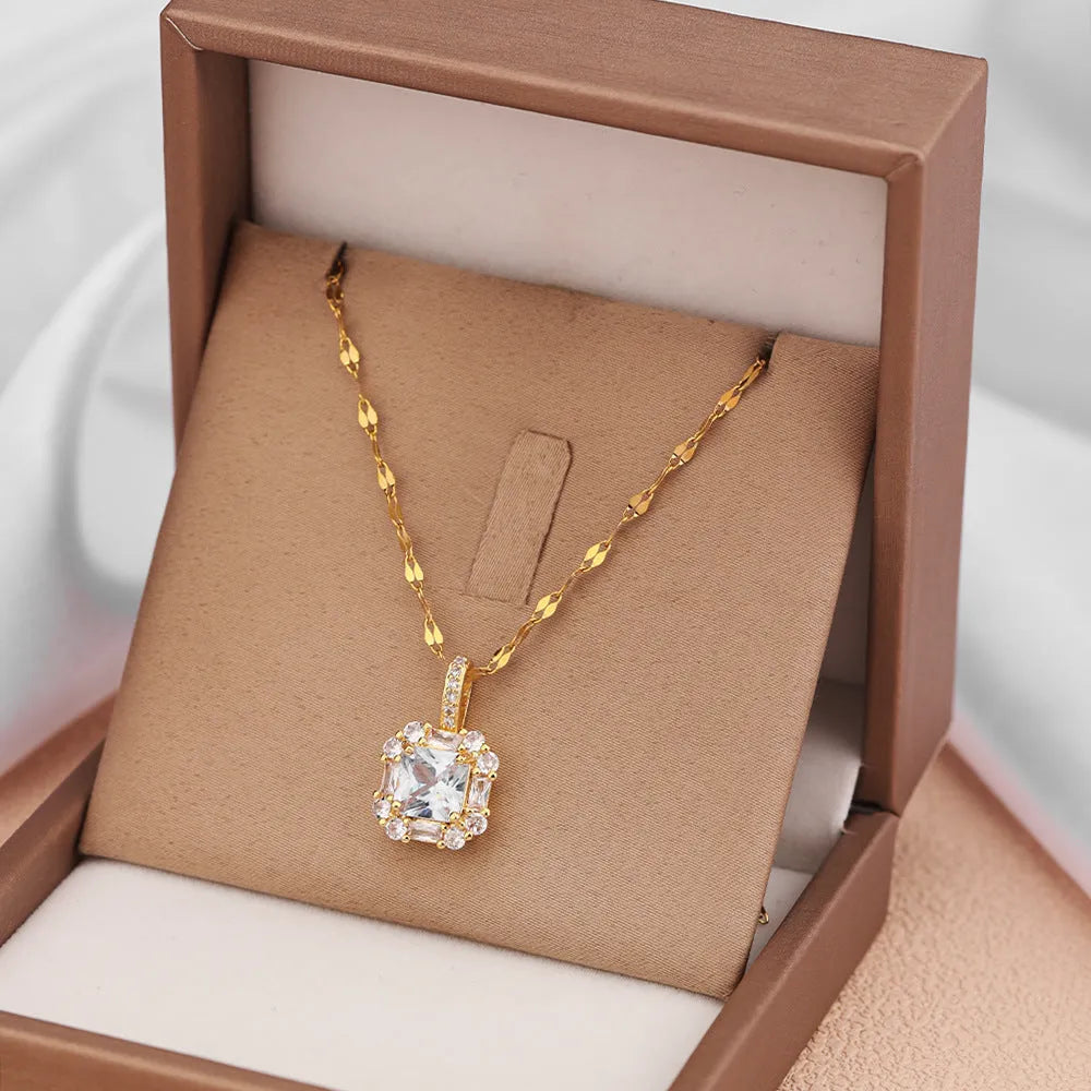 Gold-toned titanium steel necklace with geometric quadrilateral zircon pendant on a water wave chain.