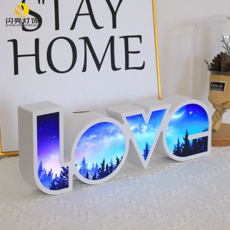 Rainbow style LED Love light for Valentines Day and wedding decoration on a table.
