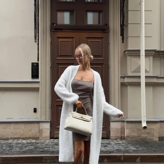 White loose-fit knitted cardigan jacket for women, shown with long sleeves.