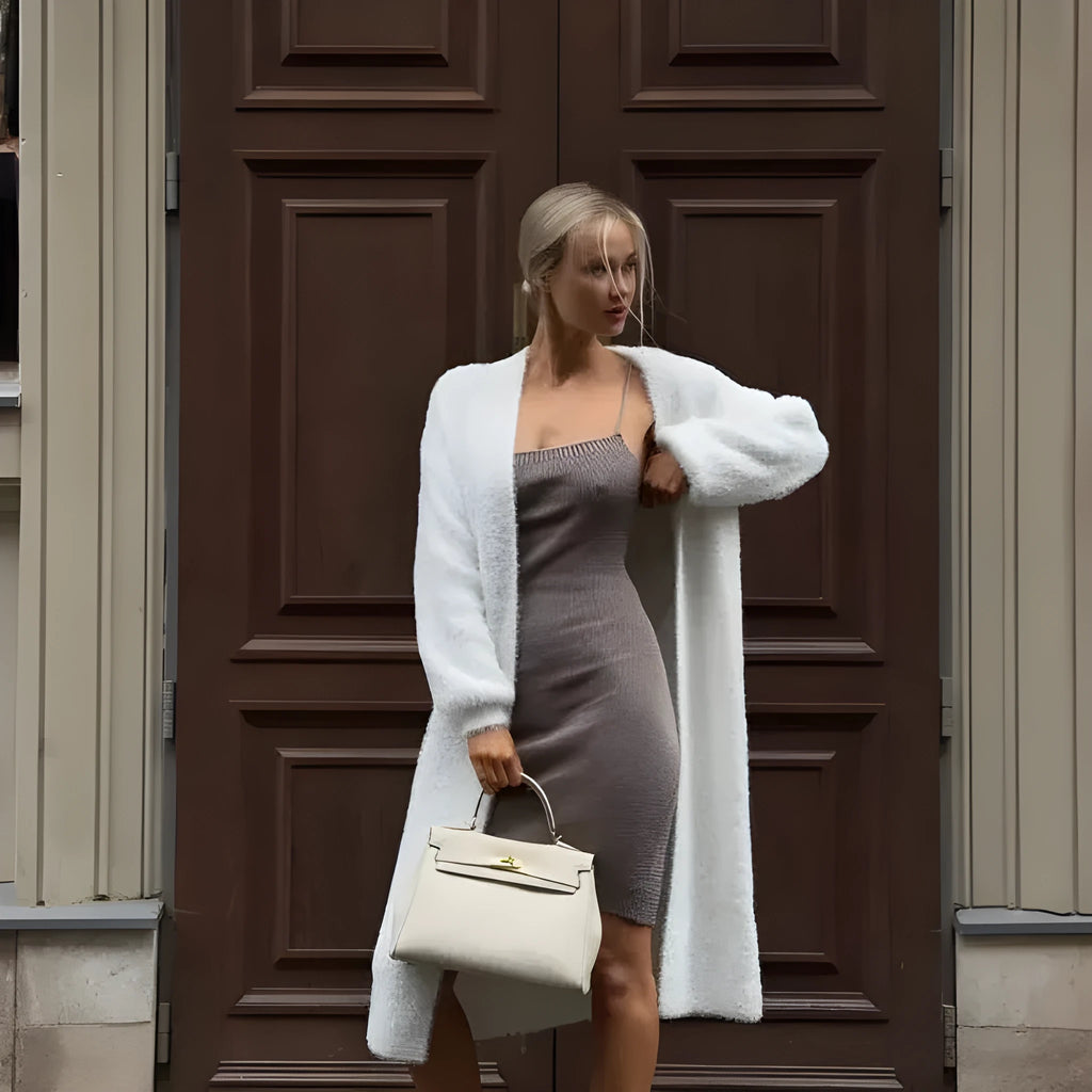 White loose-fit knitted cardigan jacket for women, shown with long sleeves.