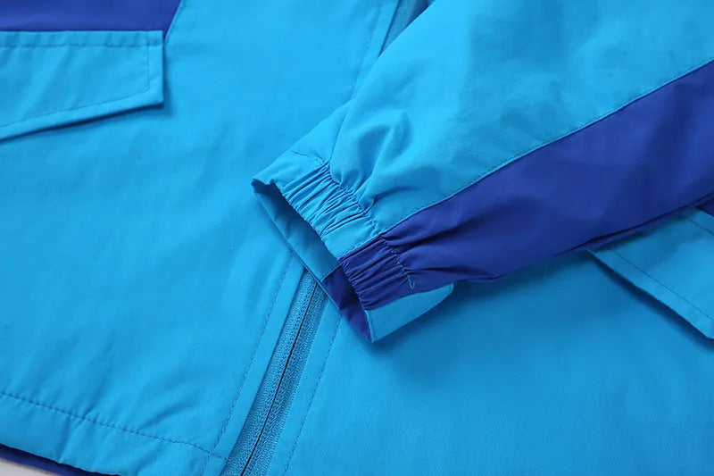 Blue boys' thin autumn jacket with long sleeves and a front zip, laid flat.