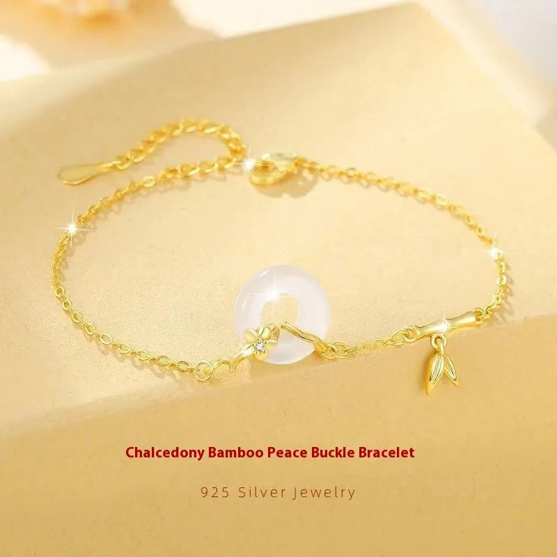 Women's silver bracelet with peace buckle clasp and white chalcedony gemstones in gold finish