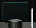 3D acrylic message board night light with remote control and stylus on a desk.
