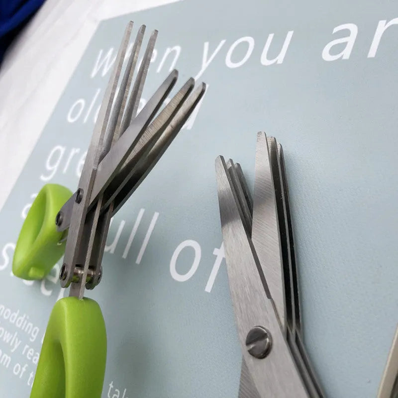 Green multi-layer stainless steel kitchen scissors for cutting herbs and green onions.
