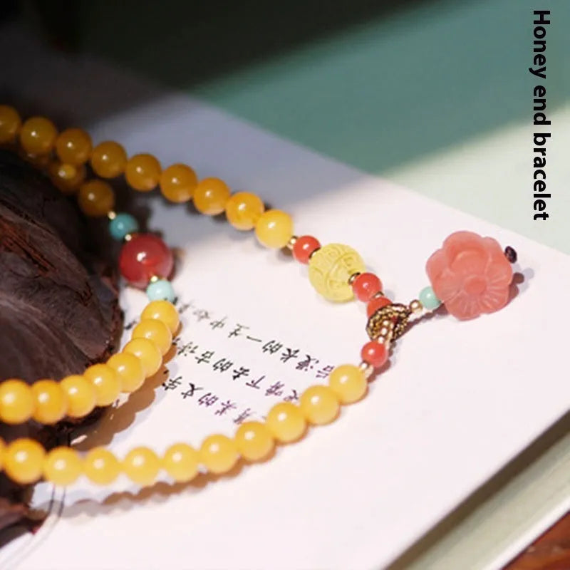 Women's retro-style amber bracelet with animal zodiac modelling in yellow chicken grease colour, 5mm round beads.