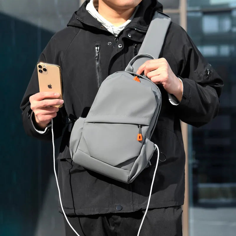 Mens black casual crossbody bag with single shoulder strap, made from waterproof polyester