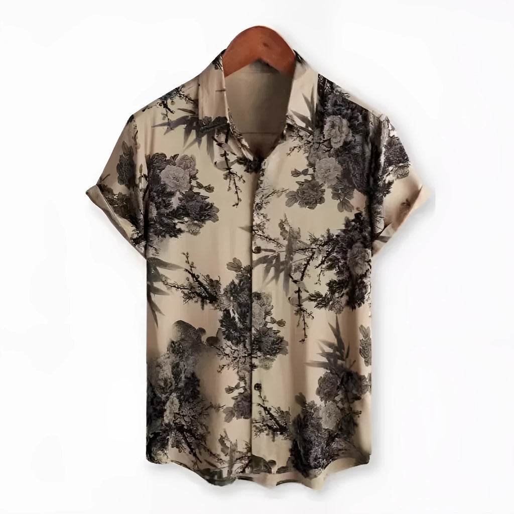 Man wearing a short sleeve Hawaiian print shirt with lapel collar in a floral pattern.