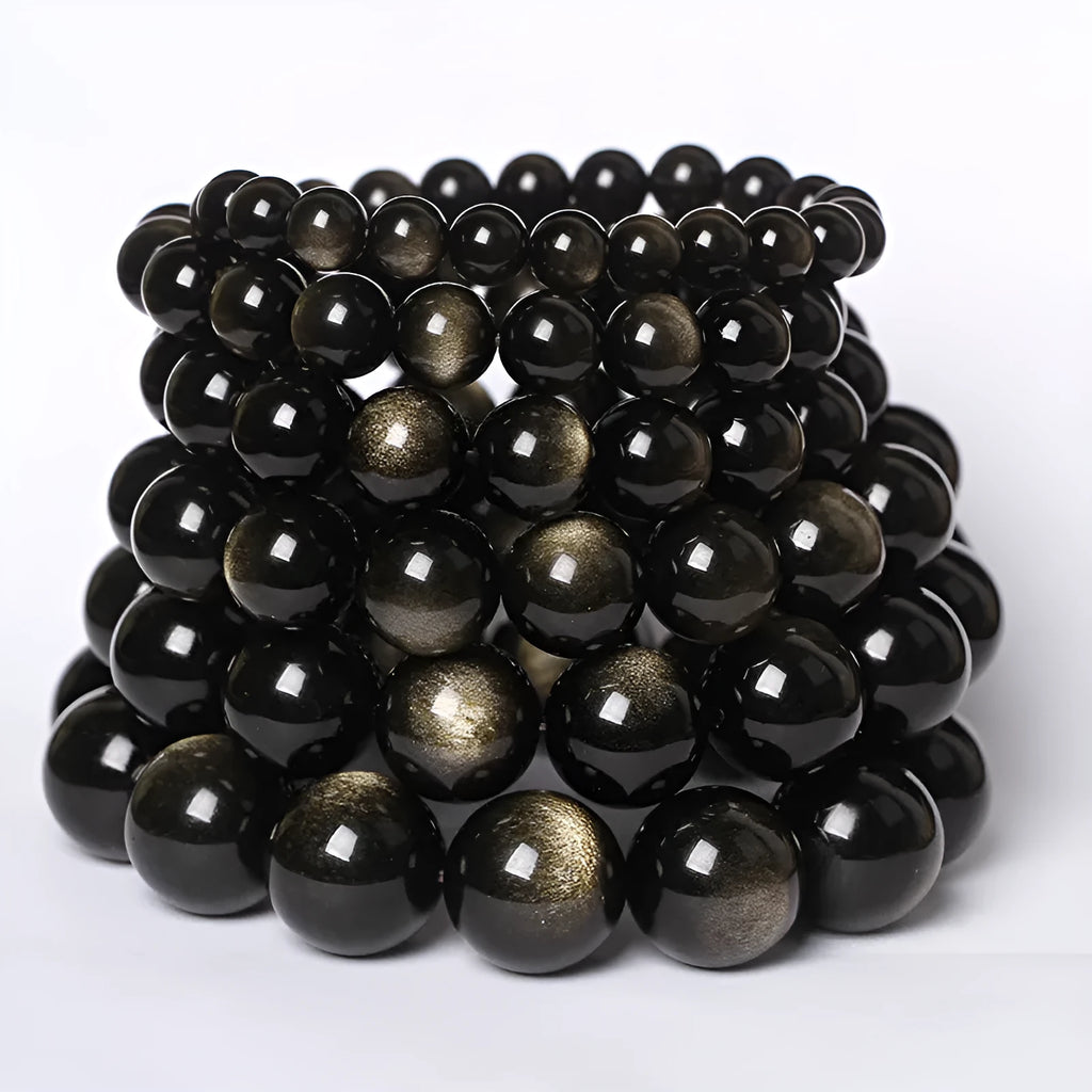 Hand-woven round obsidian crystal bracelet for couples on wrist, showing ethnic style and adjustable fit.