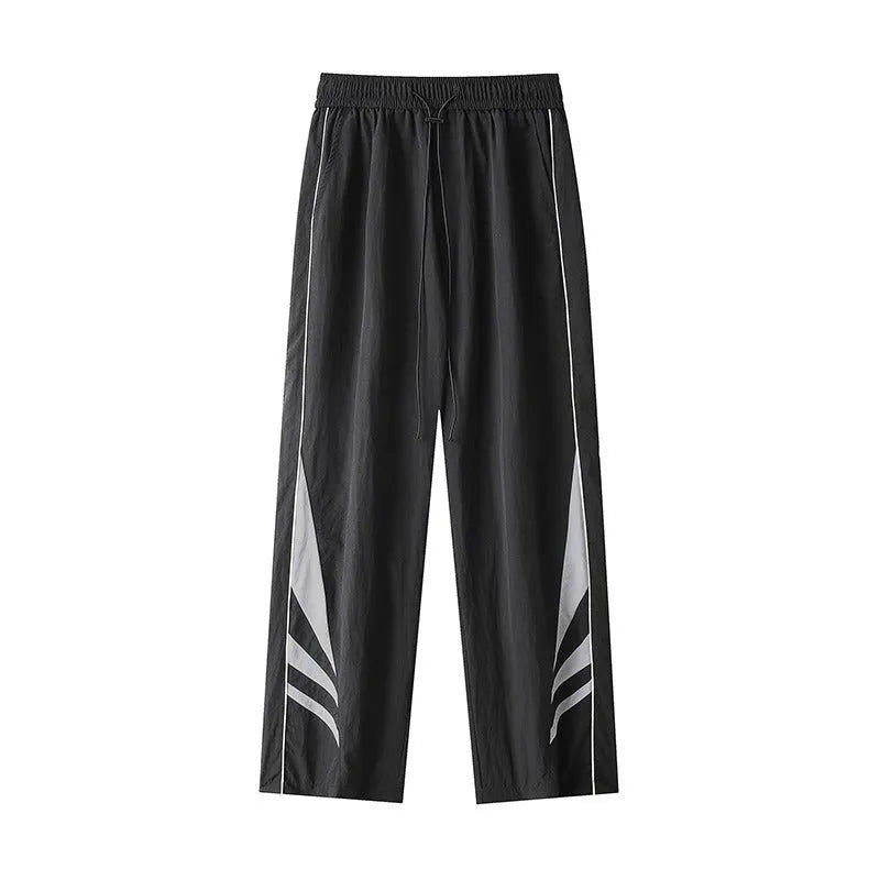 Men's black plus-size straight-leg casual trousers on a grey background, showing button detail and loose fit.