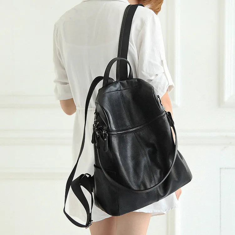 Women's genuine leather retro backpack showing internal organisation compartments and sewing thread detailing