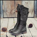 Black chunky heel high-leg casual boot with round toe and low rubber sole on a plain background.