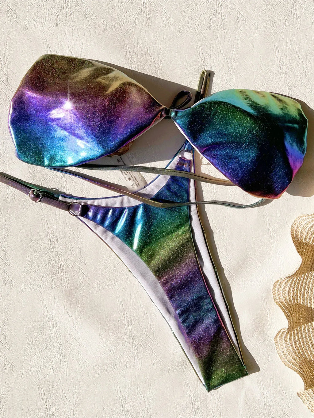 Women's gradient purple bikini swimsuit laid flat, showing top and bottom.