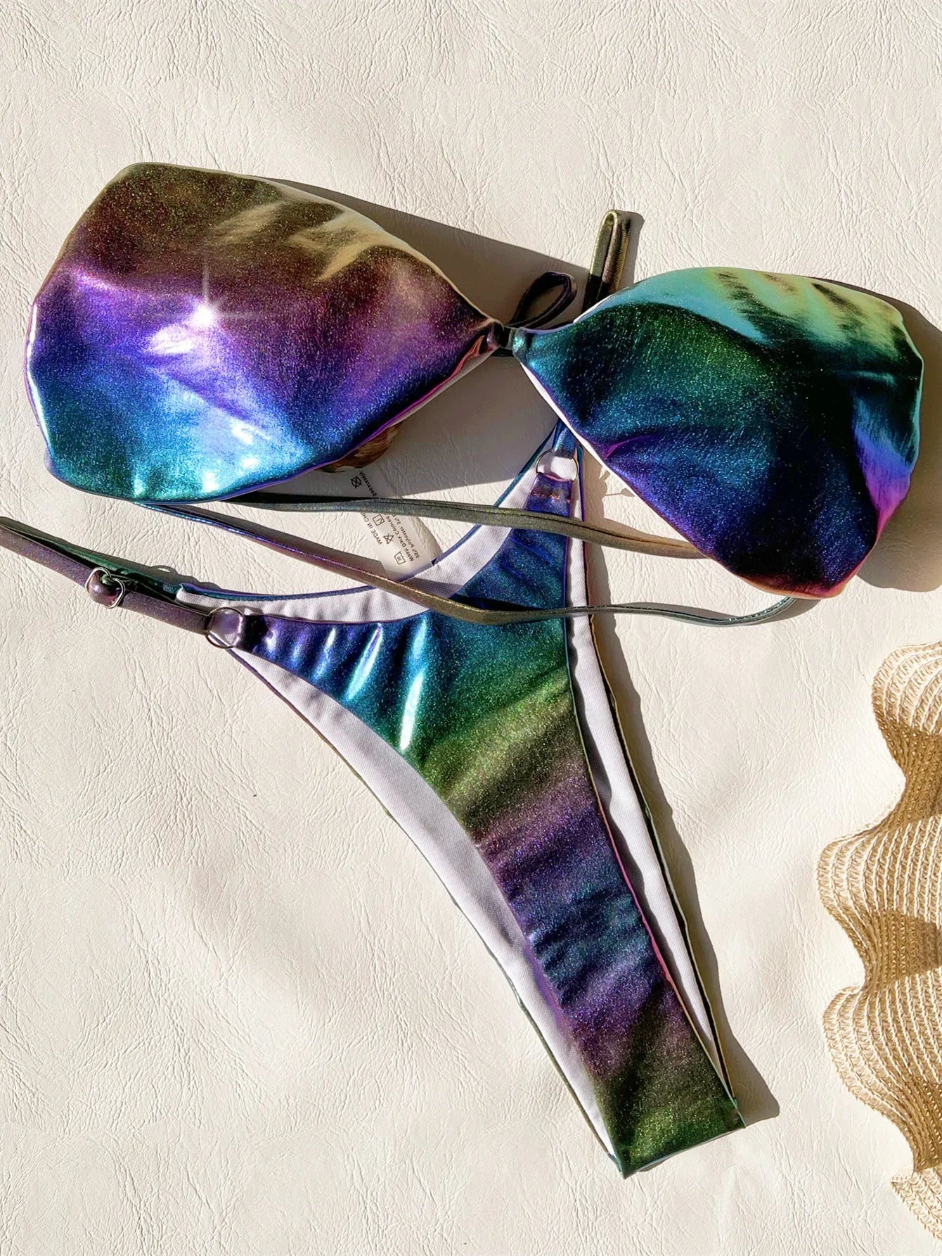 Women's gradient purple bikini swimsuit laid flat, showing top and bottom.