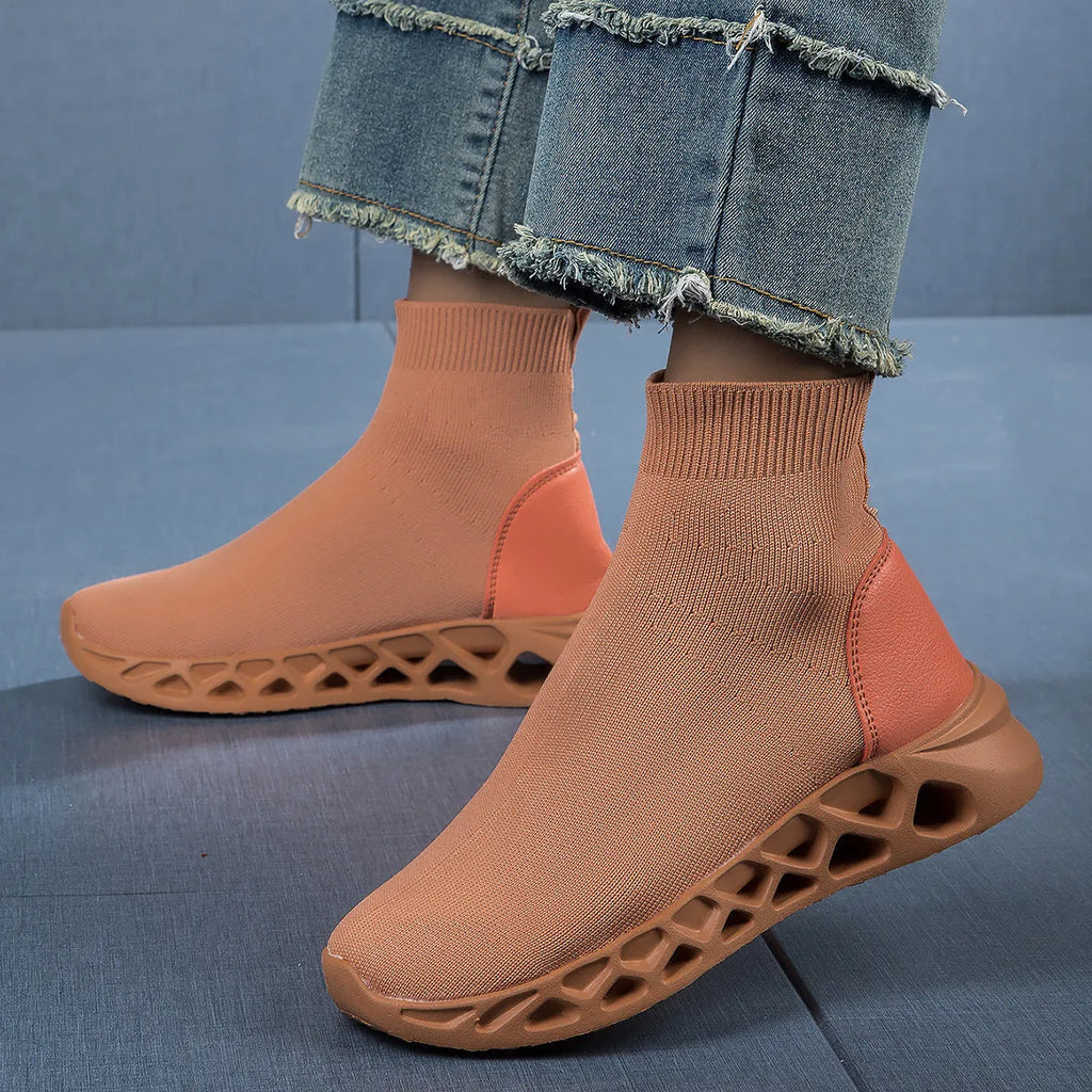 Women's black mesh slip-on casual shoe with a low-top, sock-like ankle design and flat sole.